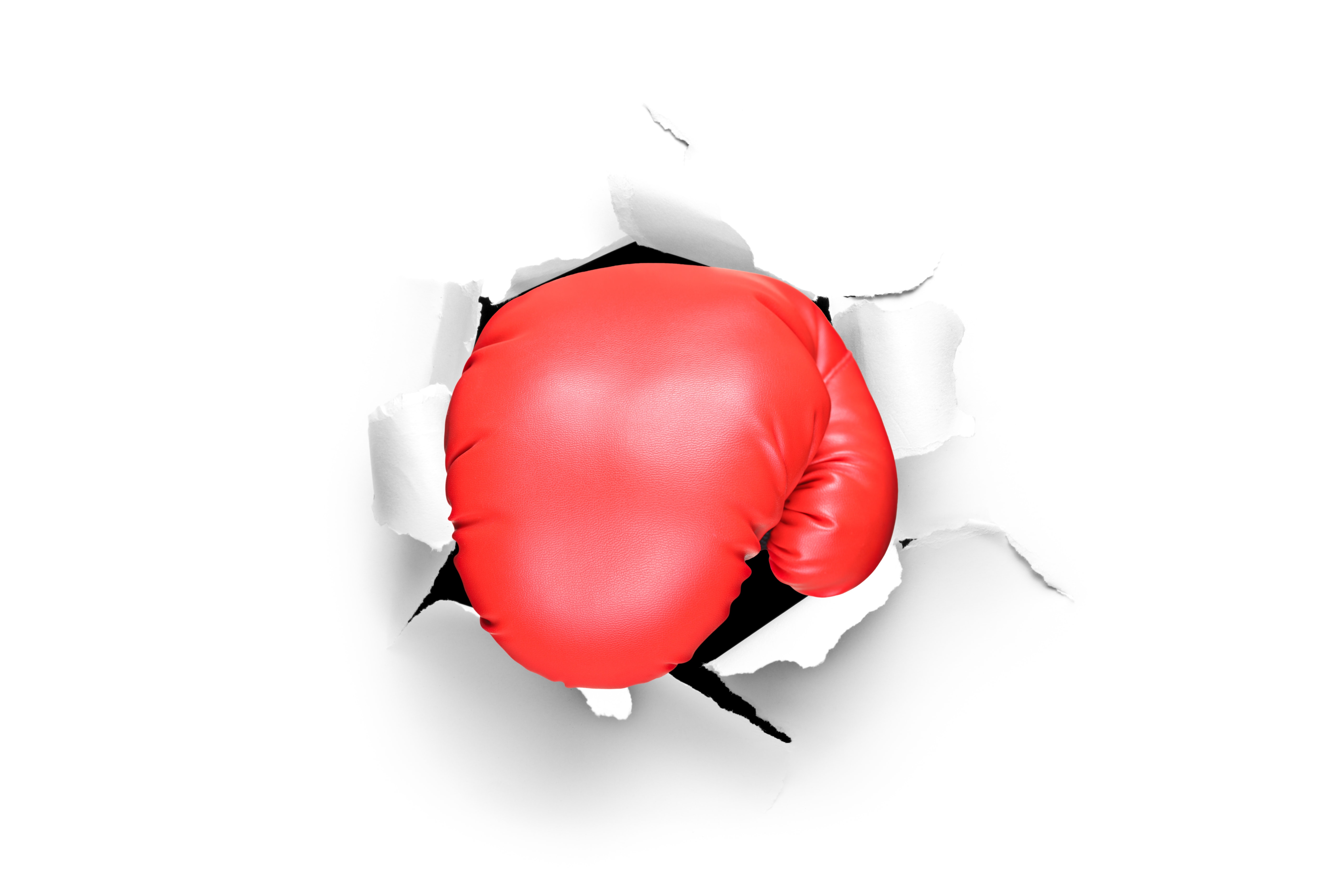 Boxing glove through a hole in paper